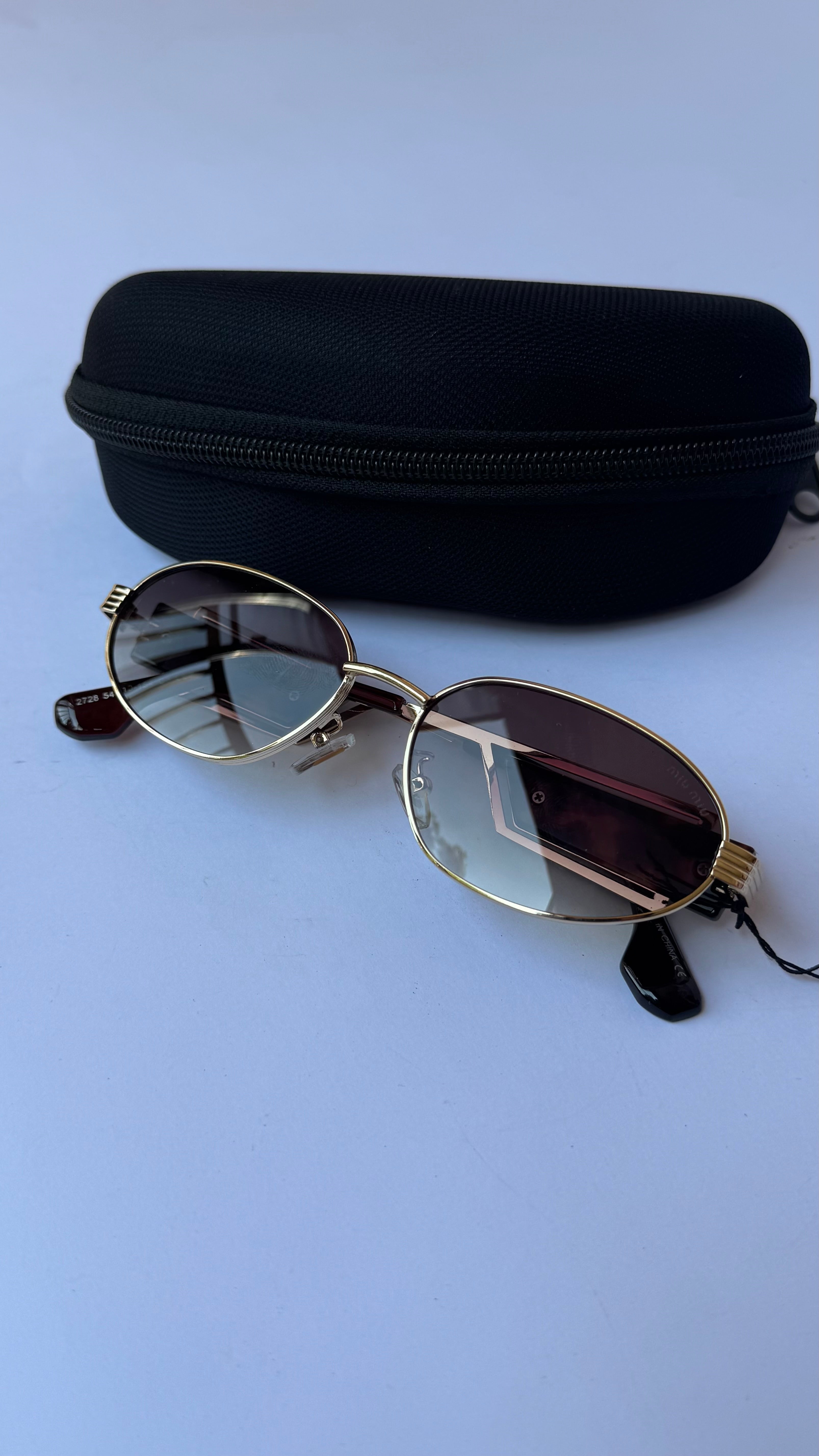 MiuMiu Oval Sunglasses